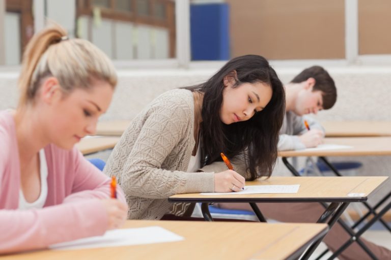 Students writing on paper