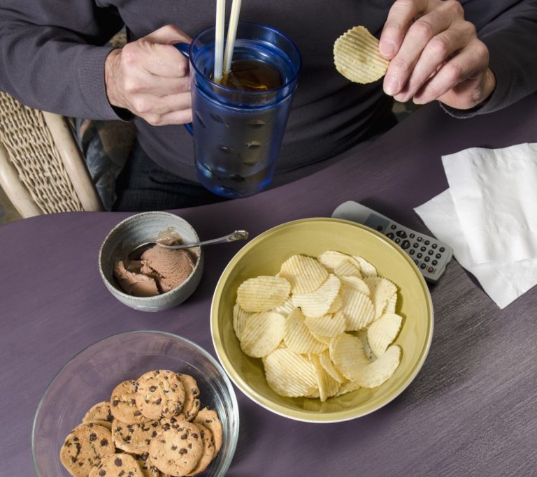 Man binge-eating junk food