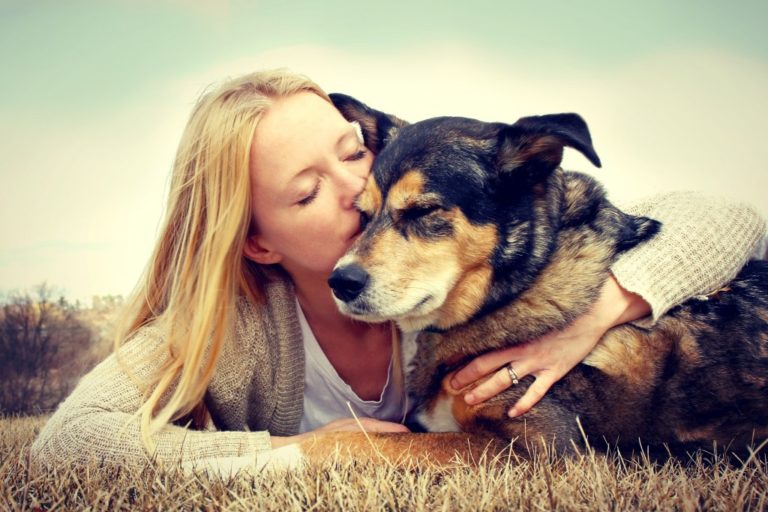 woman kissing her dog