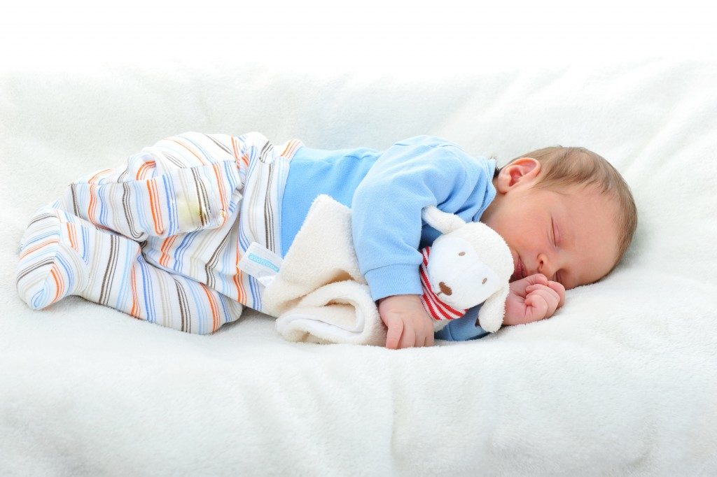 baby sleeping with a toy