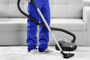 cleaning carpet with vacuum cleaner