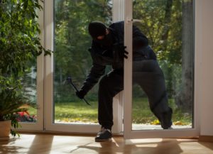 Burglar entering to house trough glass doors