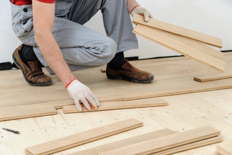 man installing flooring