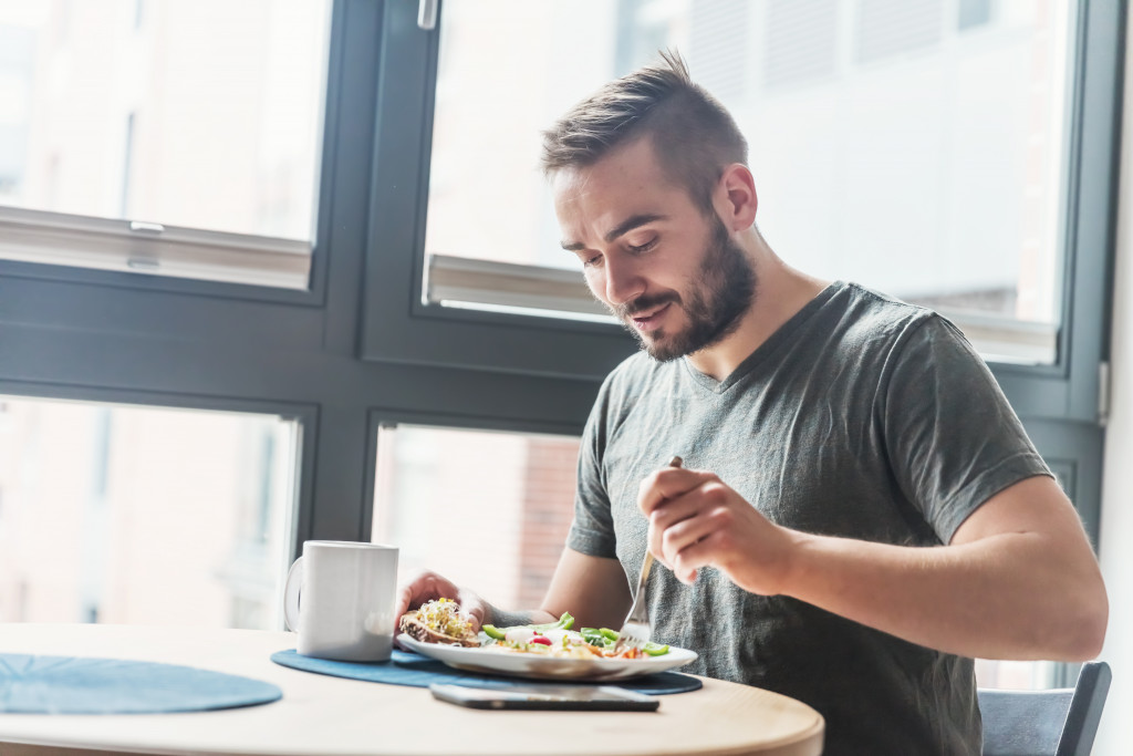 man eating a salad