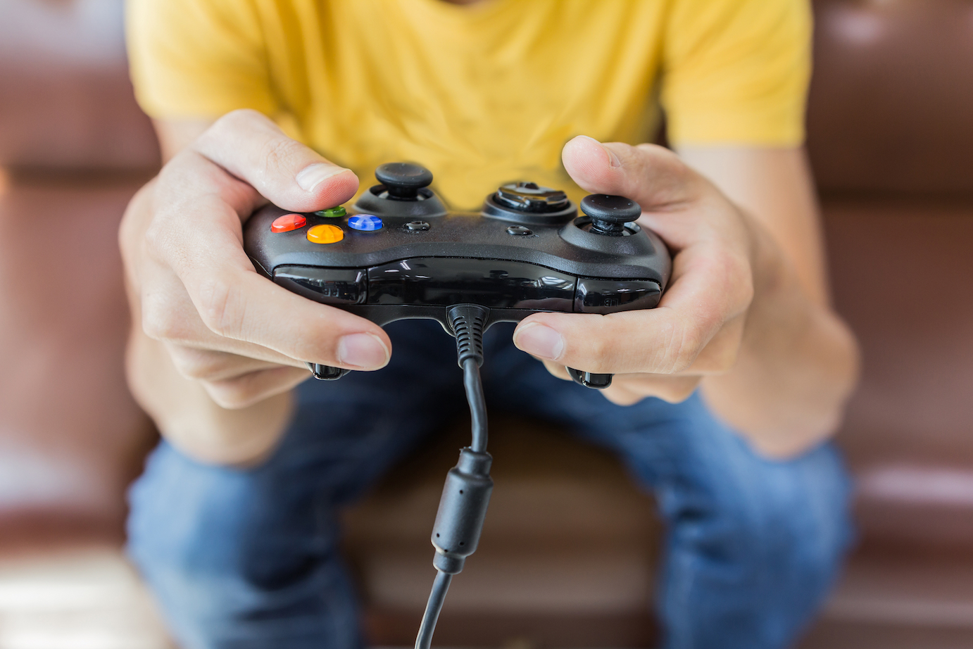 Man holding game console controller