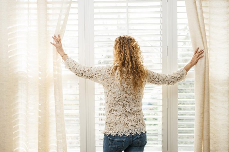 woman opening windows