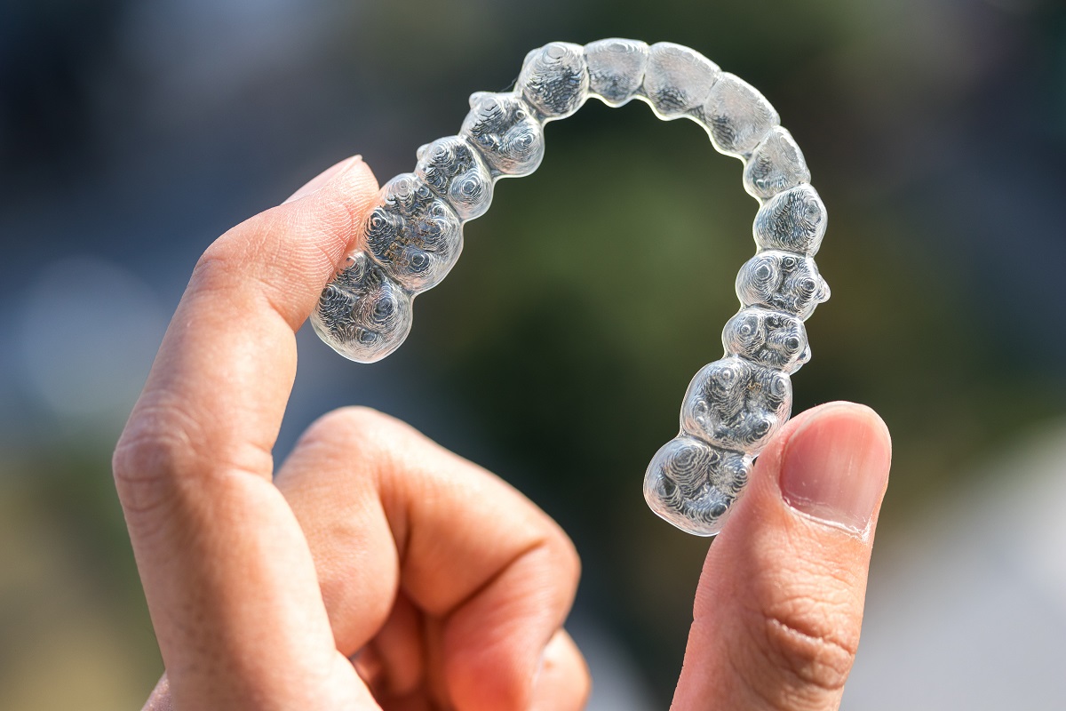 person holding an invisalign