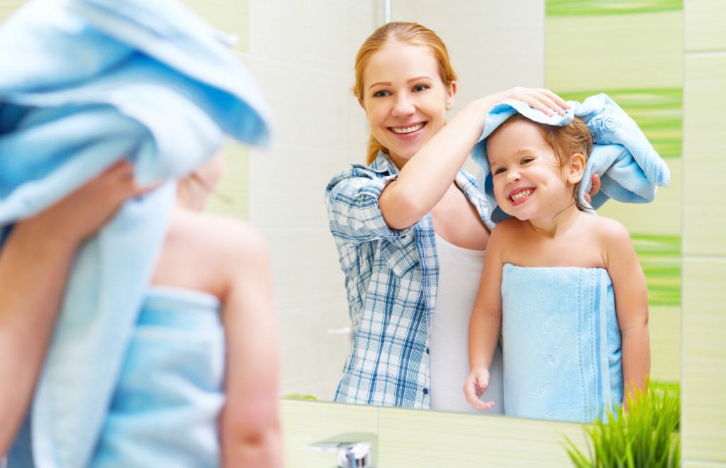 child getting dried after bath