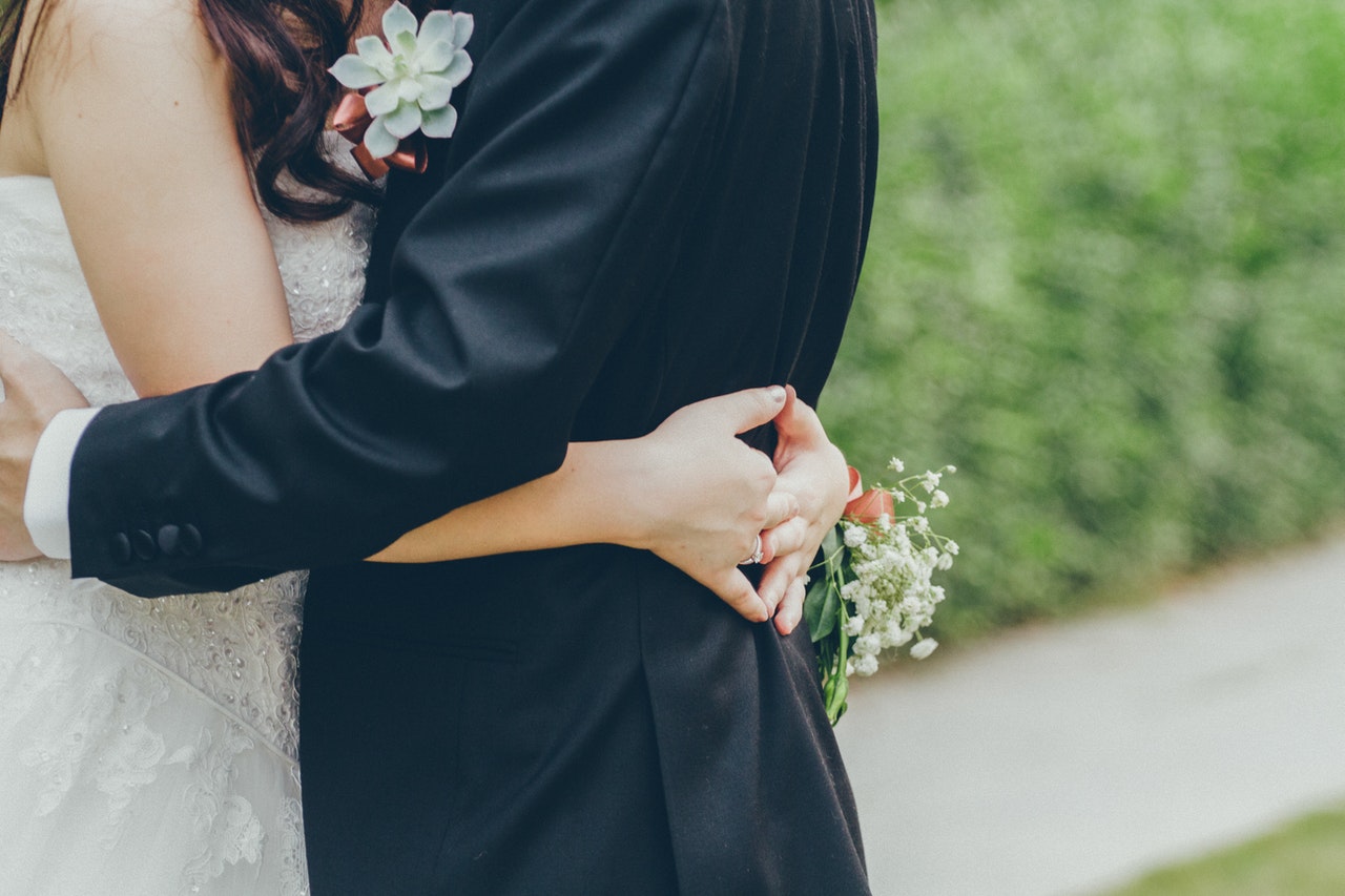 groom and bride embrace