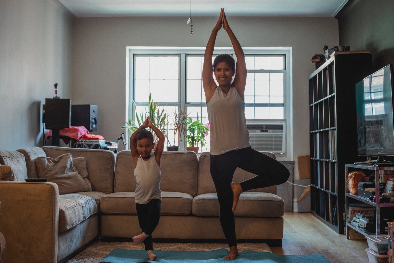 mother and daughter doing yoga