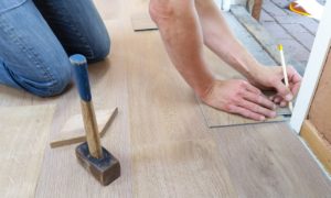 man measuring flooring