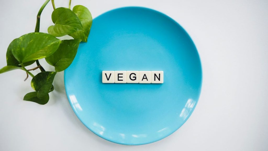 the word "vegan" on a blue plate