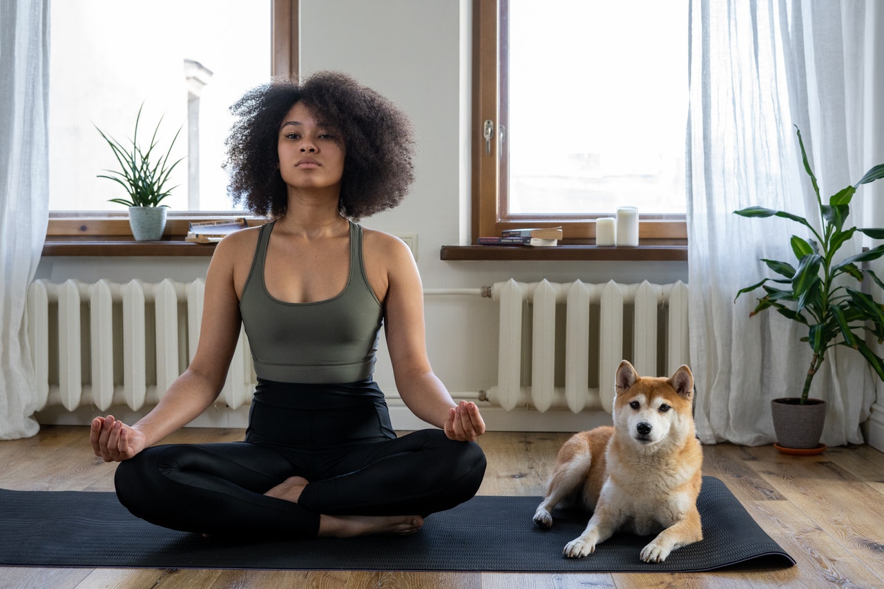 woman meditating with her dog