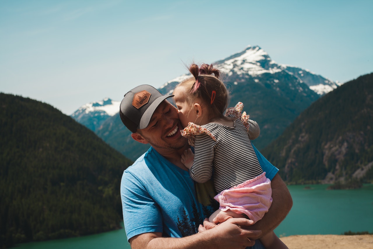 father and daughter near a lake