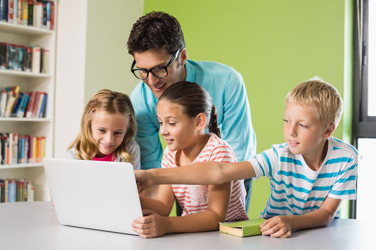 man teaching kids tablet