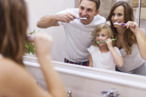 family brushing their teeth