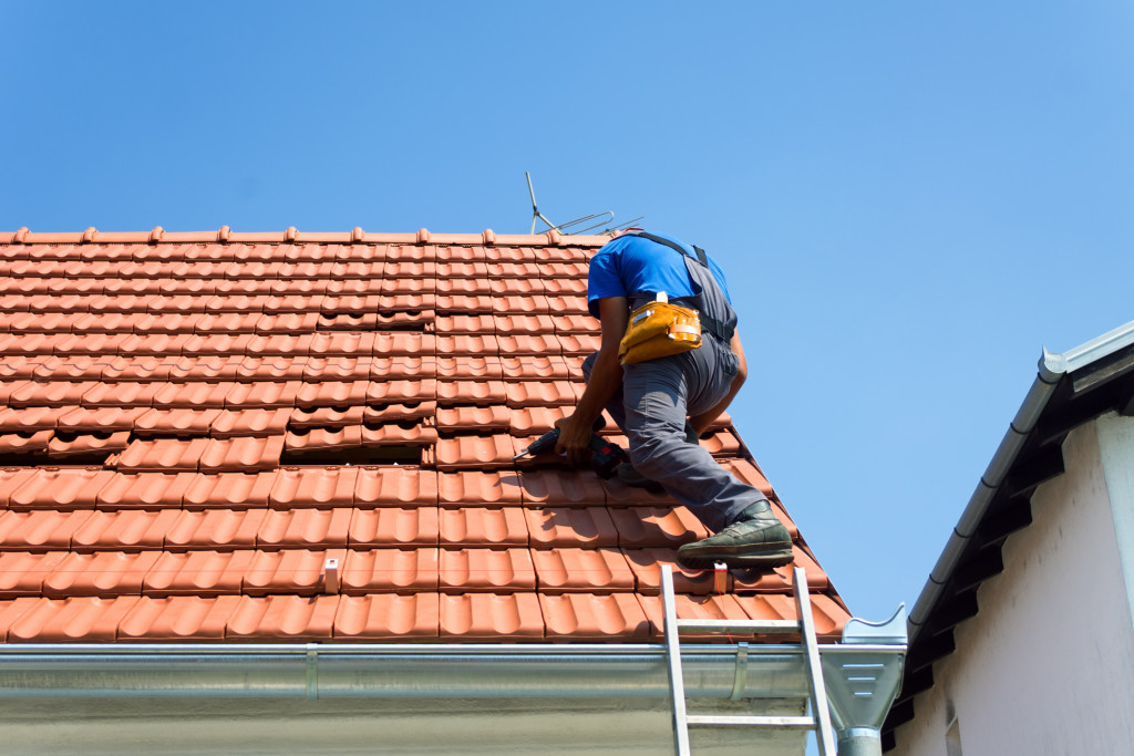 A worker repairing a roof