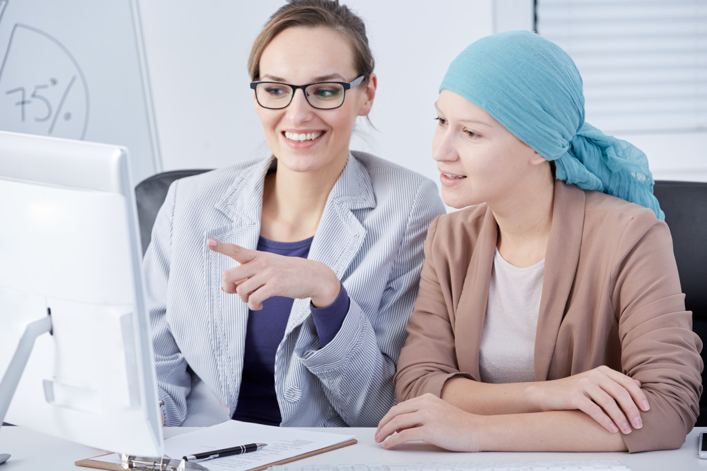 A doctor showing a cancer patient the results of her checkup