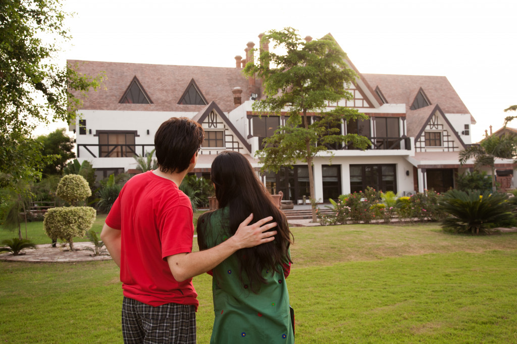 A couple outside their newly-bought home