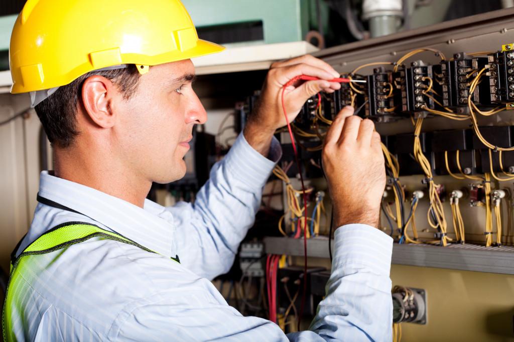 a male electrician checking wirings