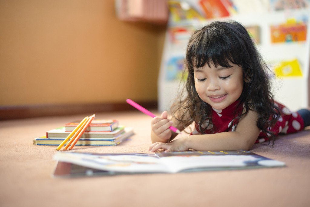 little child drawing with pencils