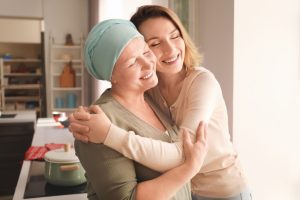 A daughter hugging a mother with cancer