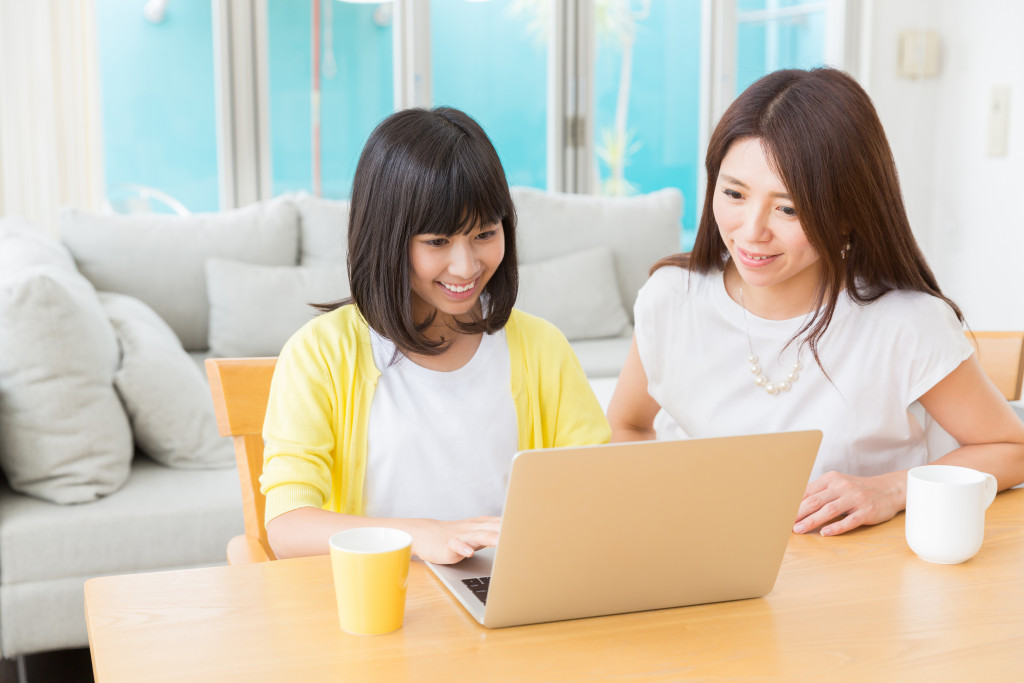 a mother and her daighter reading a book together