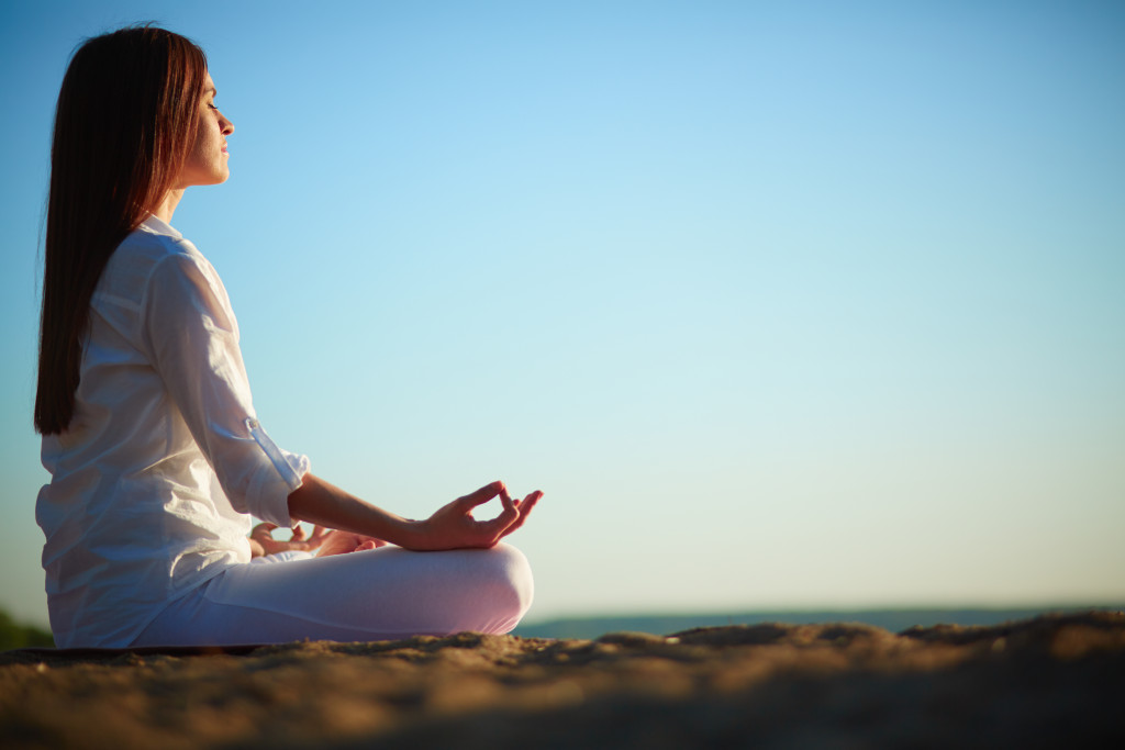 A woman meditating outdoors