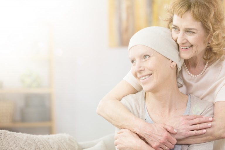 cancer patient being hugged by a loved one