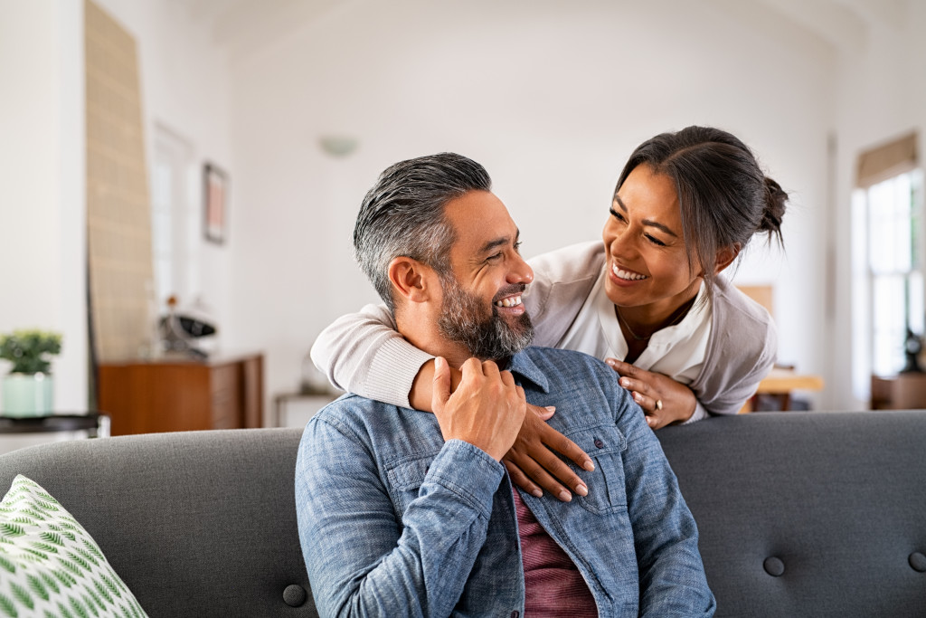 Smiling couple in their living room