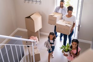 a family moving boxes and items in their new home