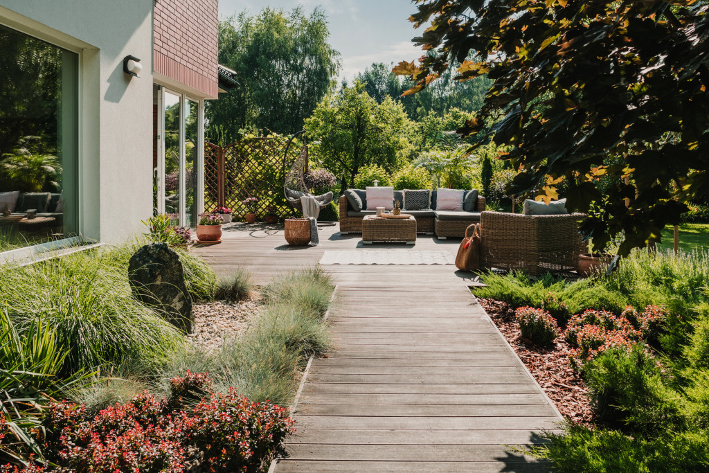 A wooden terrace path with modern garden furniture