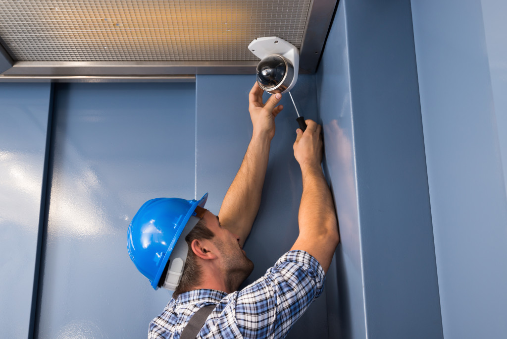 a man installing cctv camera