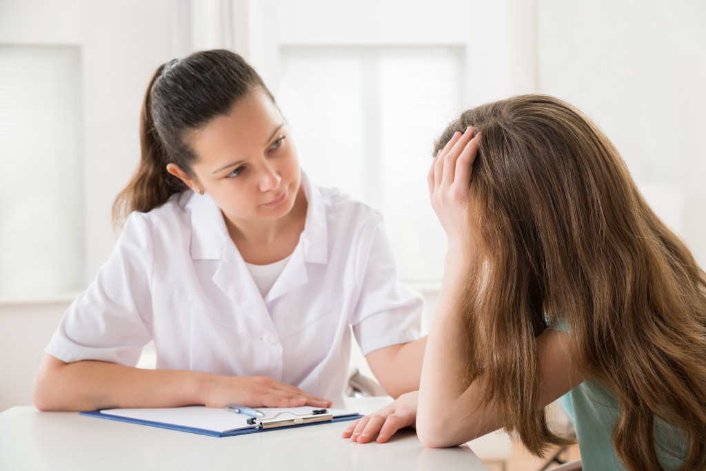 a young girl talking to a female counselor