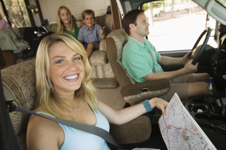 a selfie of a woman and her family on a van