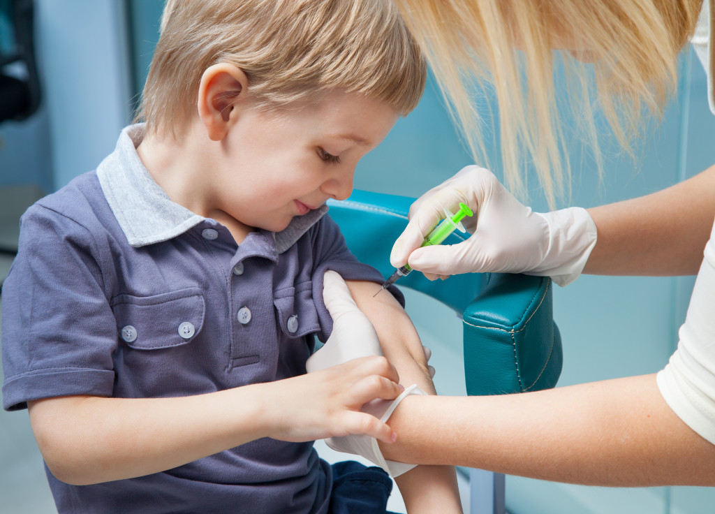 smiling boy getting a vaccine injection