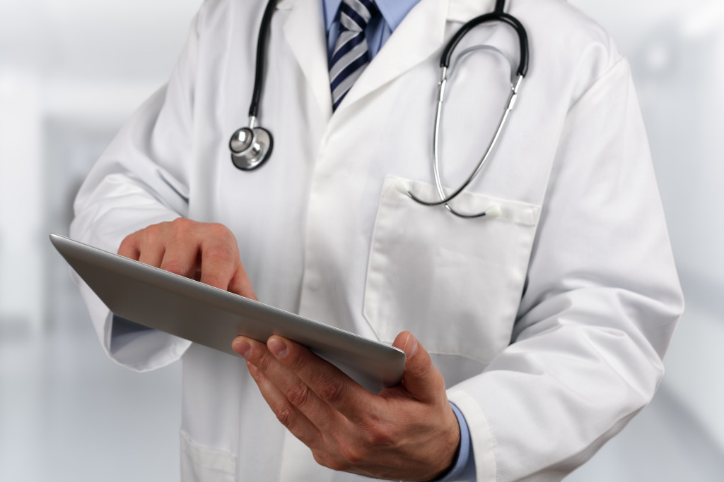 A doctor holding a digital tablet