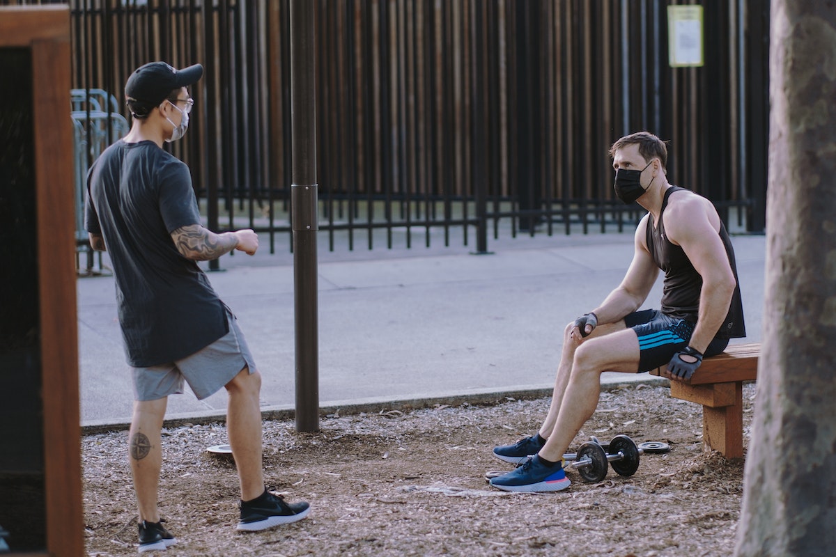 men doing workouts outdoor while on a social distancing