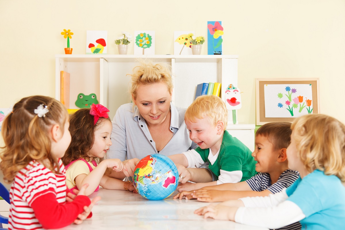 children's hands on a globe