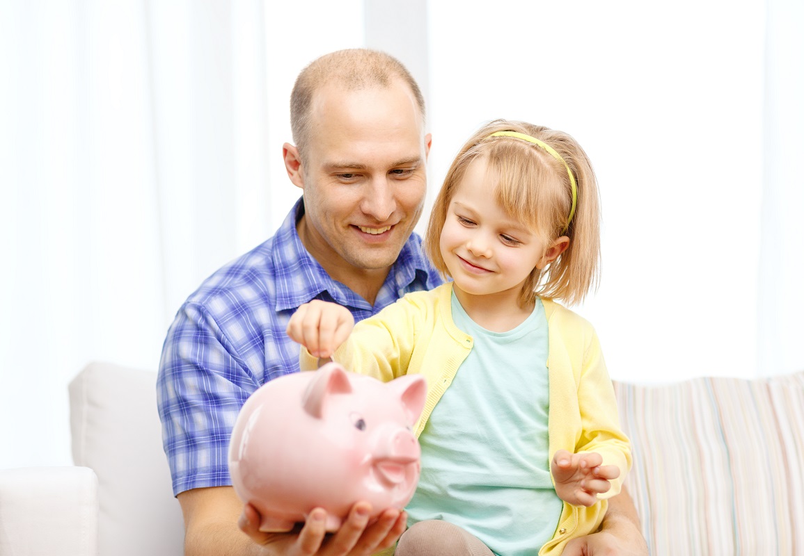 father and daughter with pink piggy bank