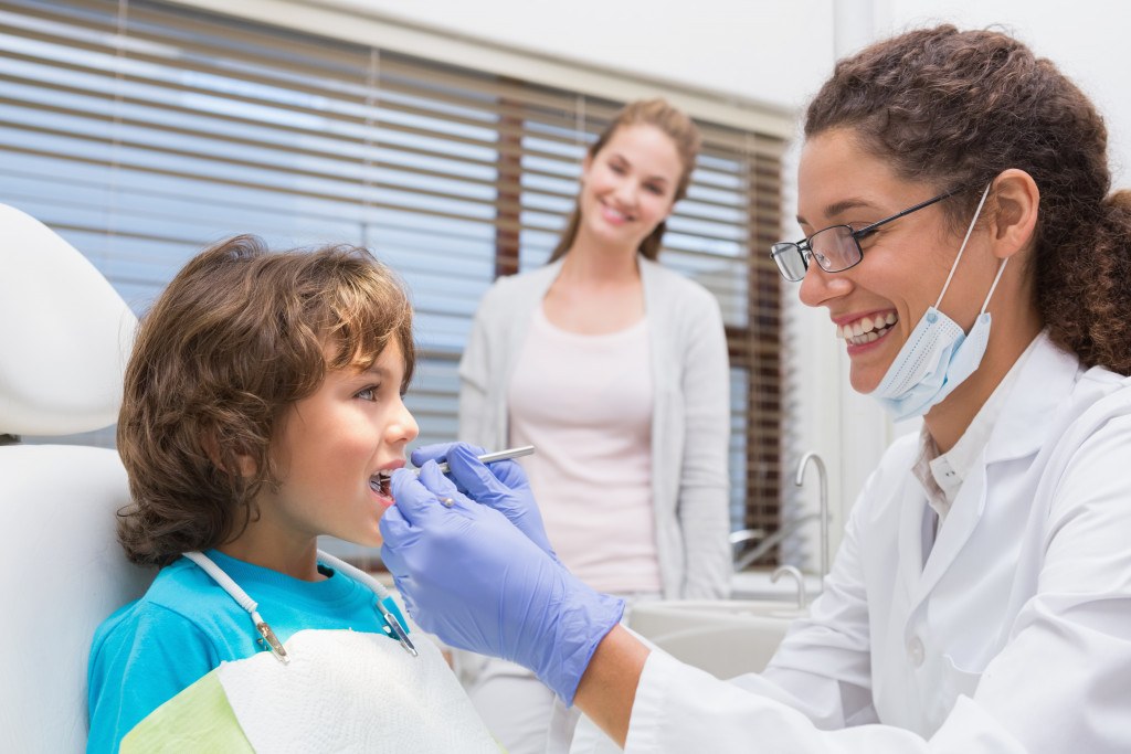 young dental patient on a checkup with his dentist