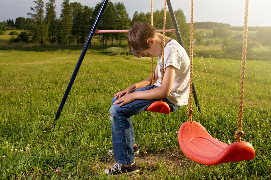 Sad child in playground