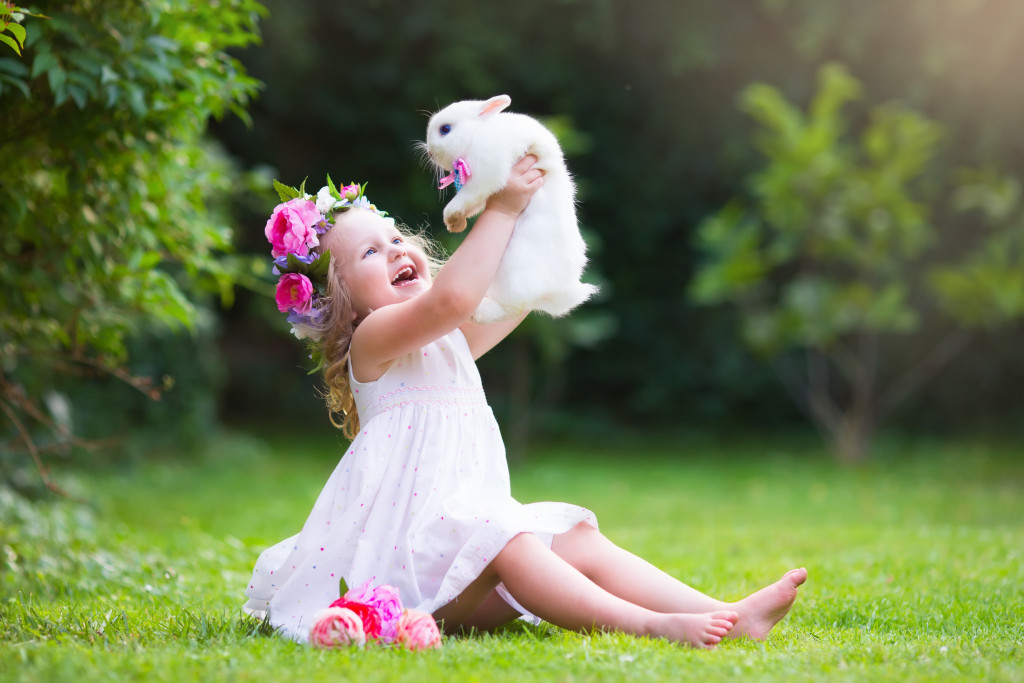 girl with bunny playing outdoor