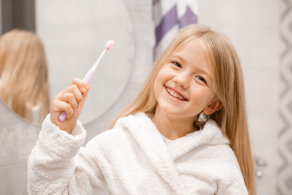 girl holding a tooth brush