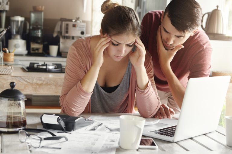 stressed couple while computing their expenses