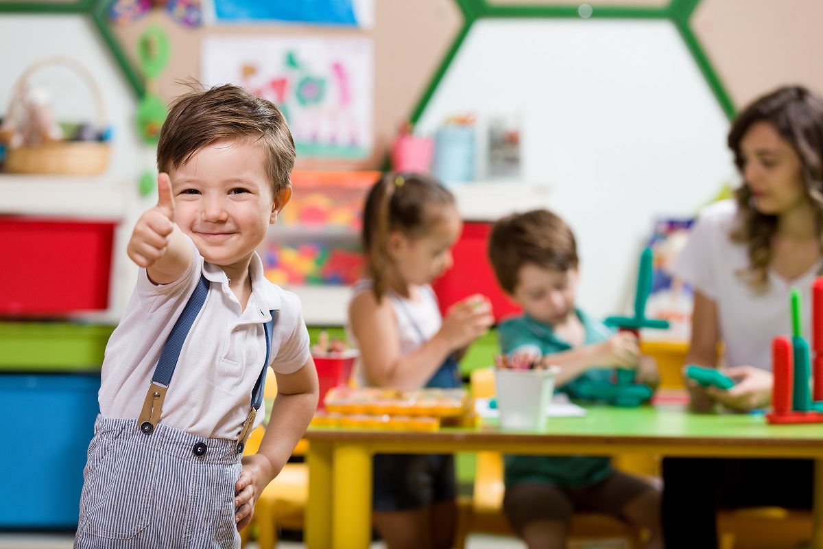 a kid giving a thumbs up