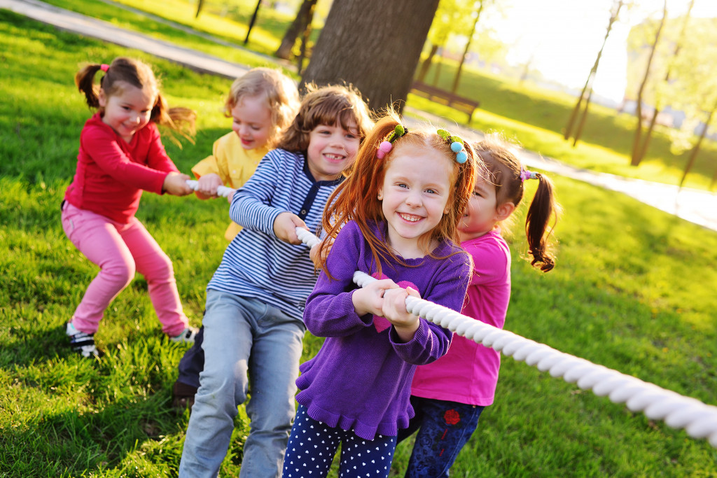 Kids playing tug of war at a park