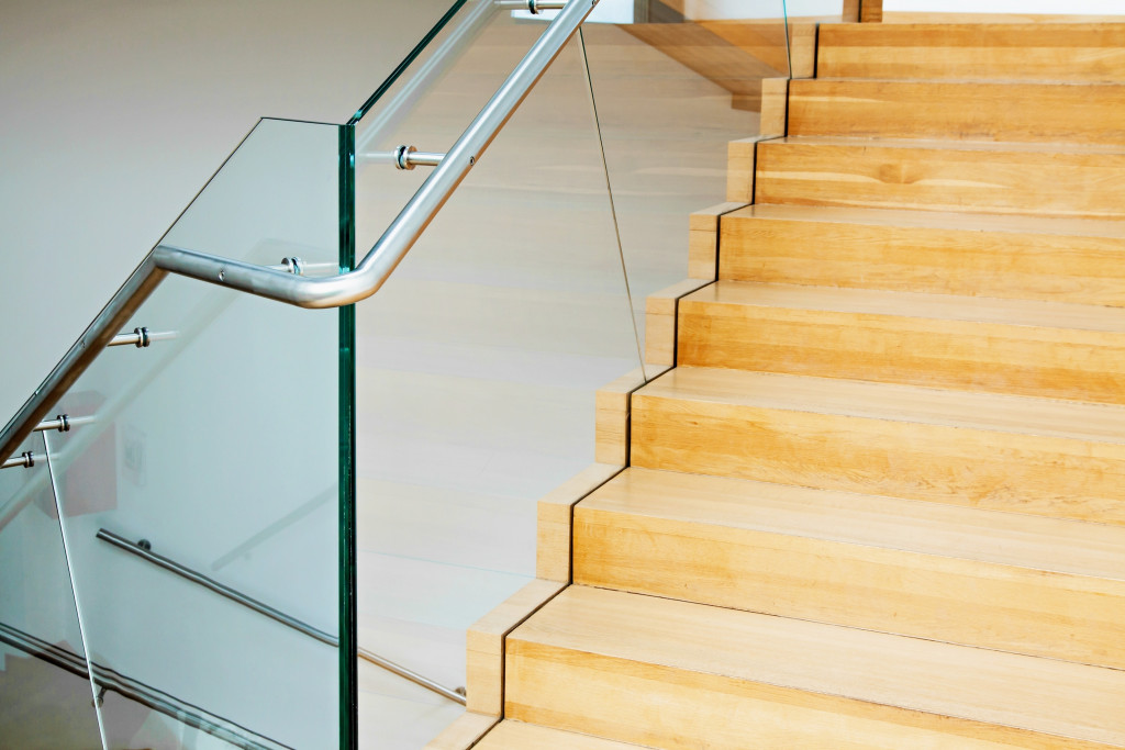 modern wooden staircase with glass balustrade