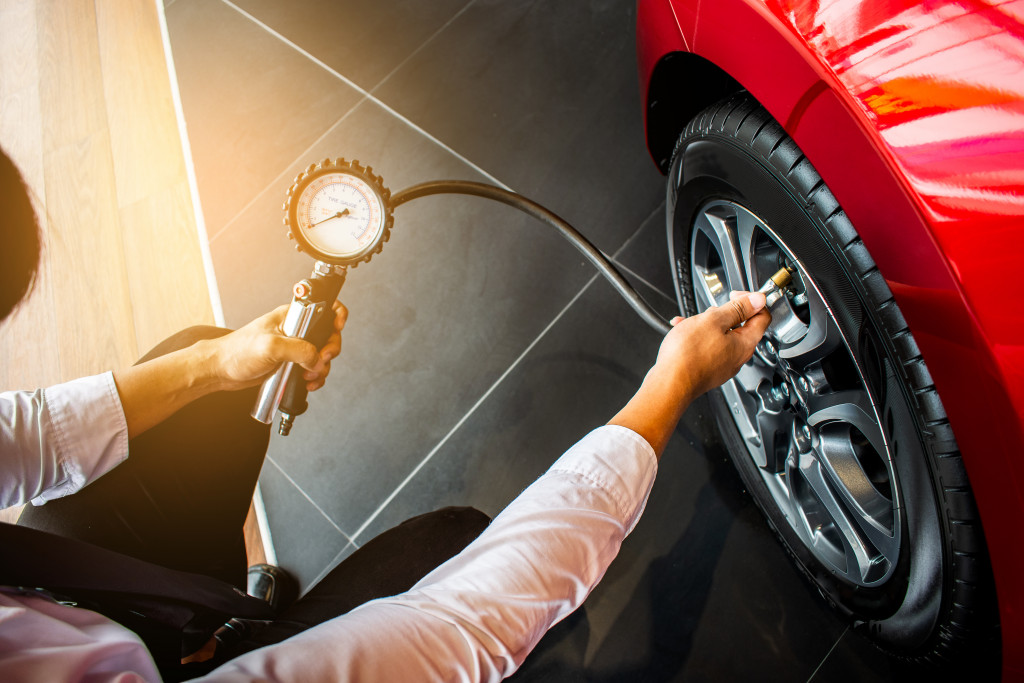 man checking tire pressure