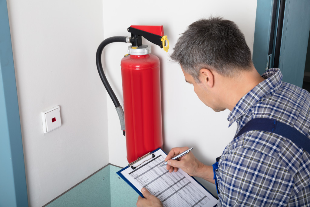 an inspector checking fire extinguisher